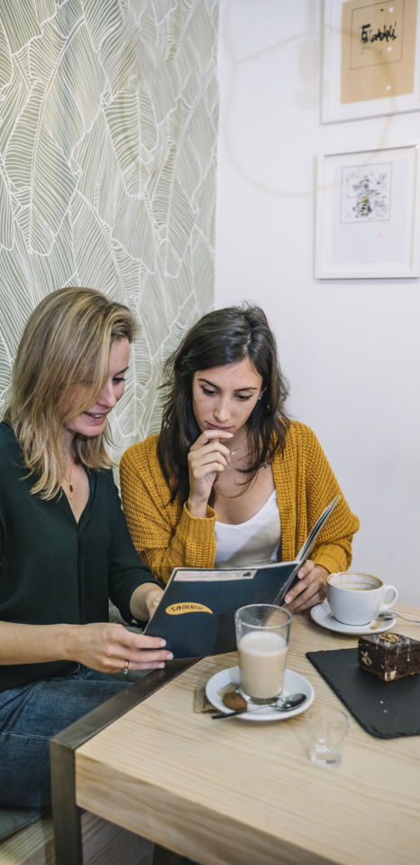 young-women-reading-menu-cafe.jpg